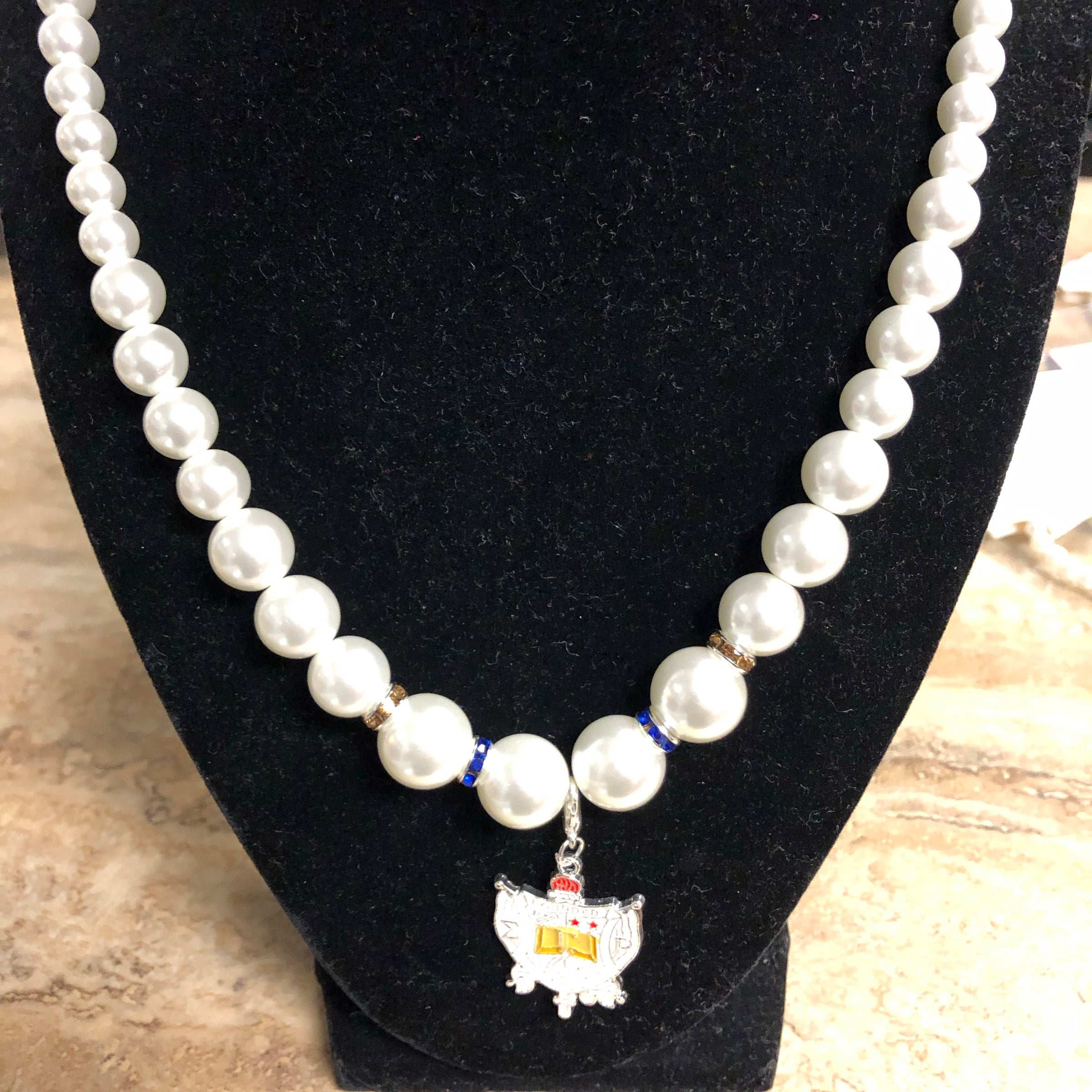 SGRho Pearls with Shield Charm Necklace